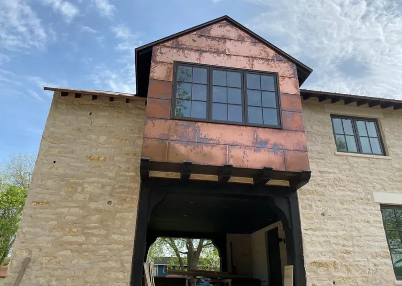Copper metal panel facade on a stone building for Skylight Installation in Carroll